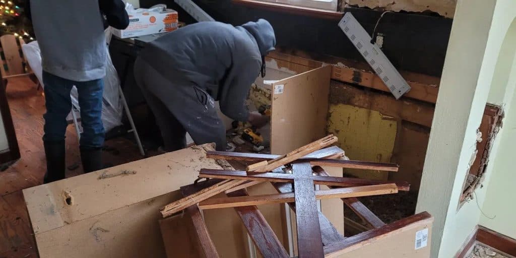 a couple kissing while walking out of a limousine while holding some drinks