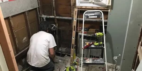 a couple kissing while walking out of a limousine while holding some drinks