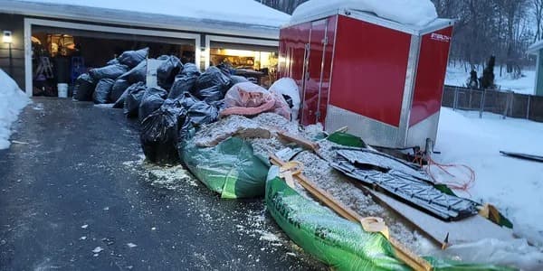 a couple kissing while walking out of a limousine while holding some drinks